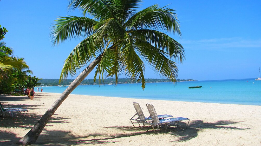 Two lounge chairs on Negril beach in Jamaica