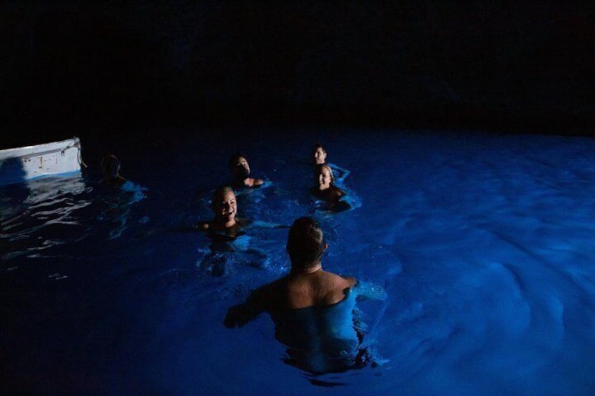 Those in the know soak up the strikingly blue waters of a local cave.