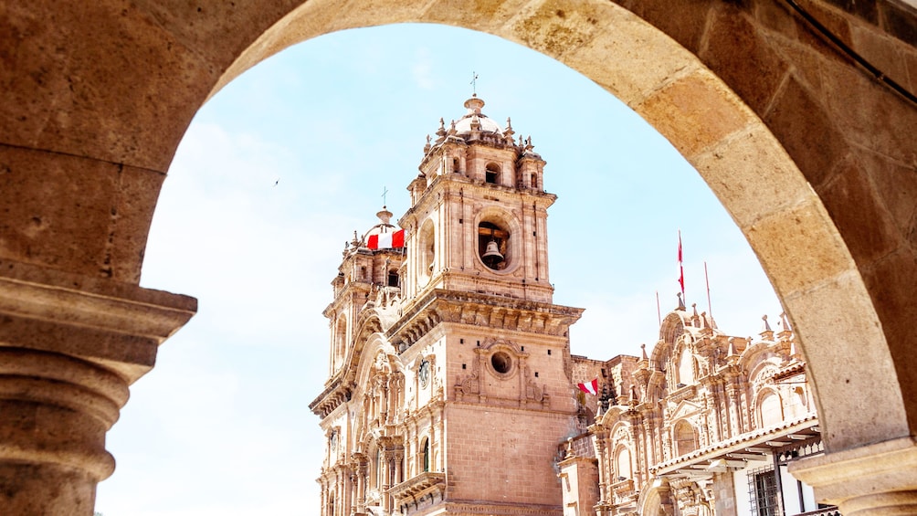 La Plaza de Armas as seen through an arch in Cusco Peru