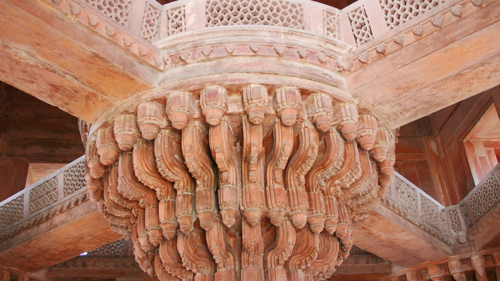 detail of ornately carved architectural elements at a historical site in India