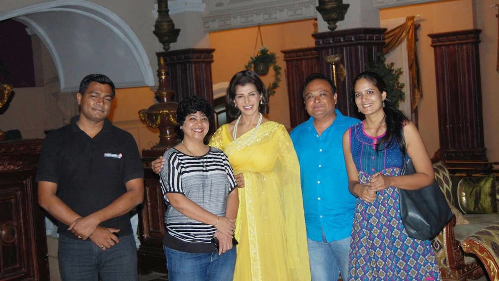 Tour group posing for a photo at a Bollywood studio in Mumbai