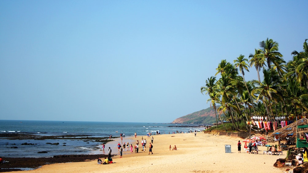 visitors enjoying the sun at the beach in Goa