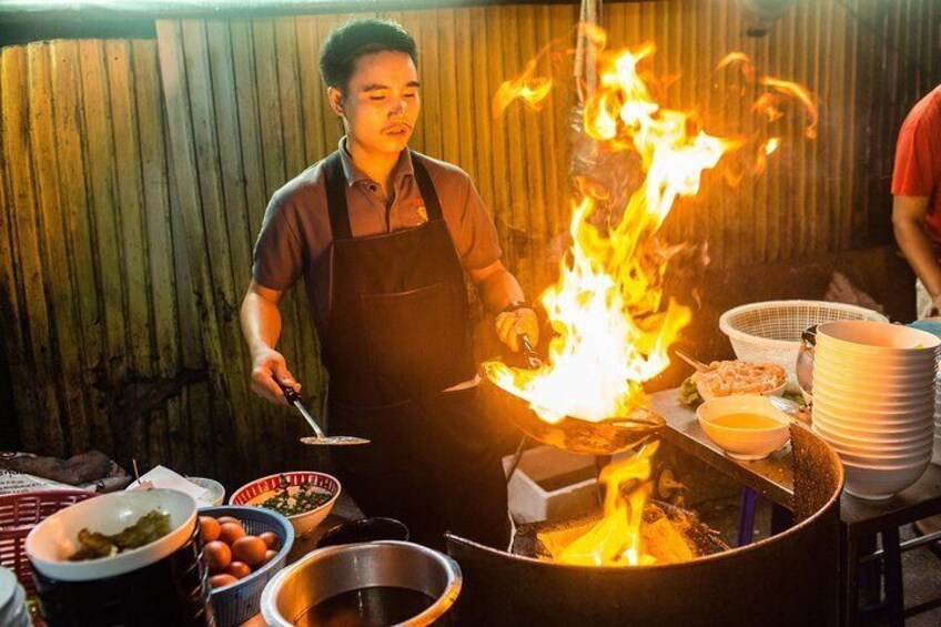 Thai chef cooks traditional street food, Bangkok, Thailand.