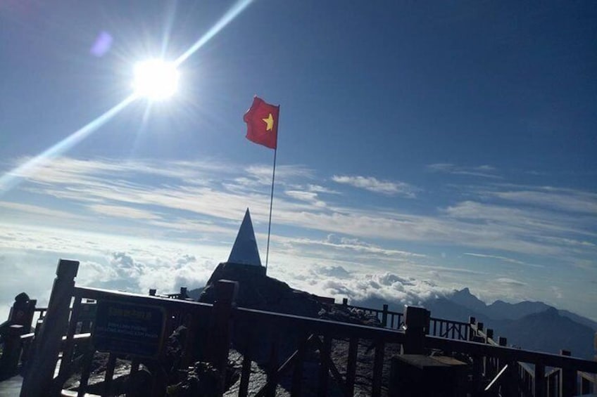 Vietnam flag with sunrise on Fansipan peak