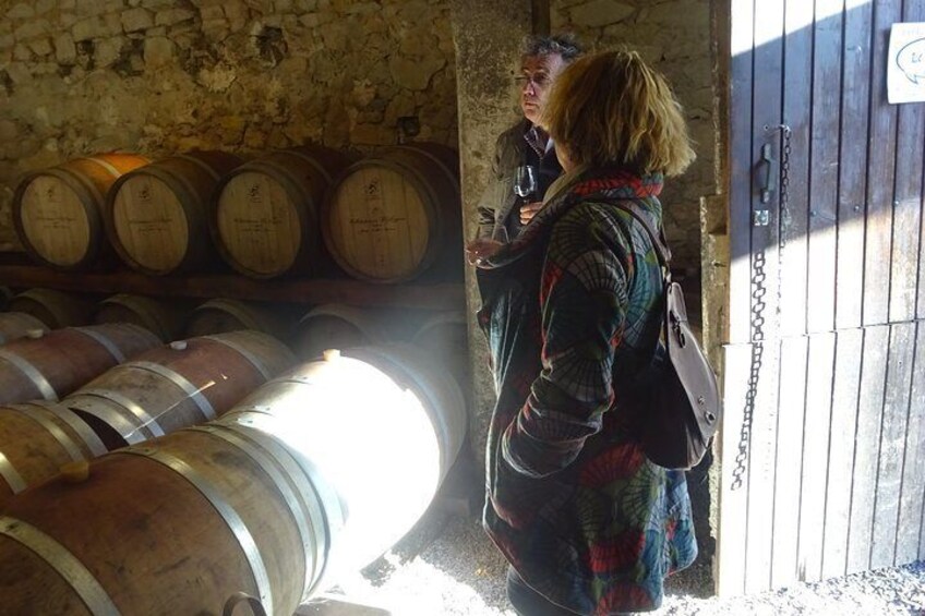 Cellar with oak tree barrels at a winery in Pic Saint-Loup, Languedoc.