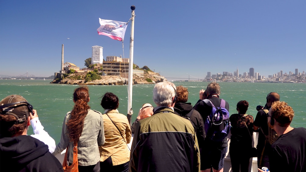 Tour group looking at Alcatraz from a boat in San Francisco