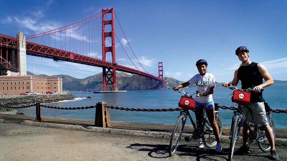 Bicycling couple with the Golden Gate Bridge in San Francisco