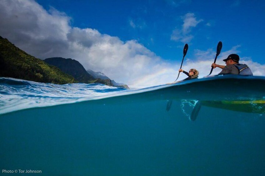 Paddling off Na Pali Coast cliffs
