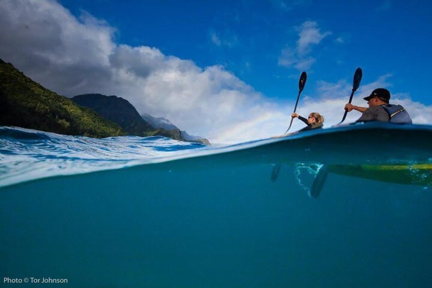 Paddling off Na Pali Coast cliffs