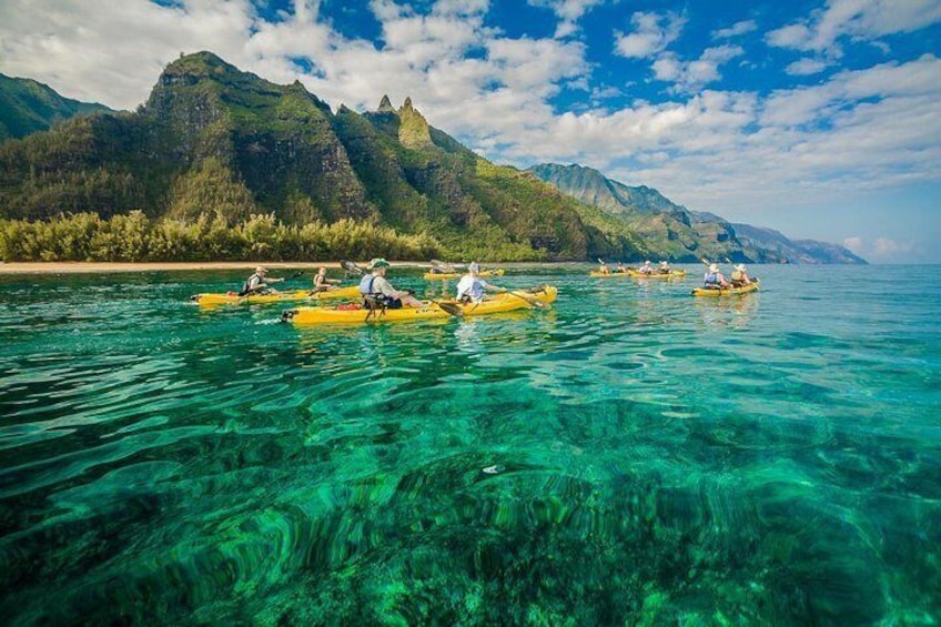 Sea kayaker Na Pali coast unfolding