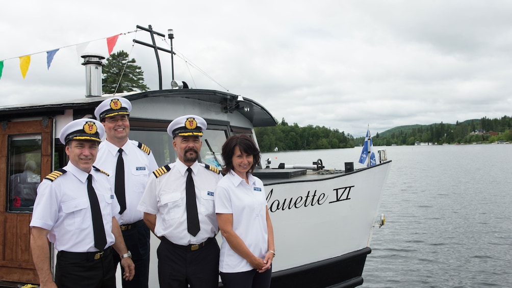 The crew posing in front of a boat on the Lac des Sables outside Montreal Canada