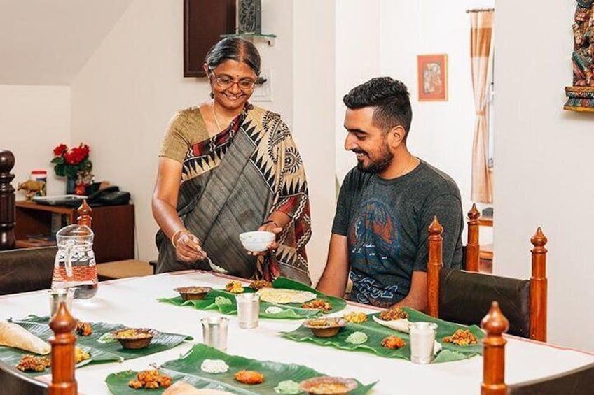 Kamala serving a lavish South Indian meal