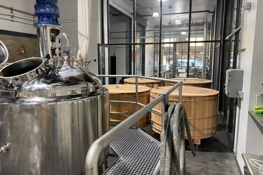 Mash tun and wooden washbacks in the brewhouse. 