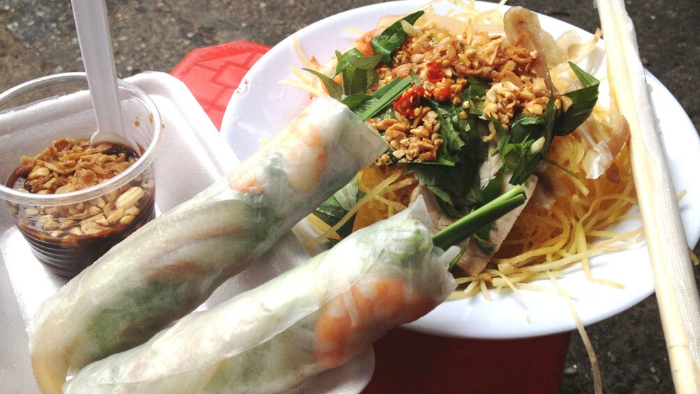 Spring rolls and a papaya salad dish on the Saigon Street Food Tour in Ho Chi Minh City 