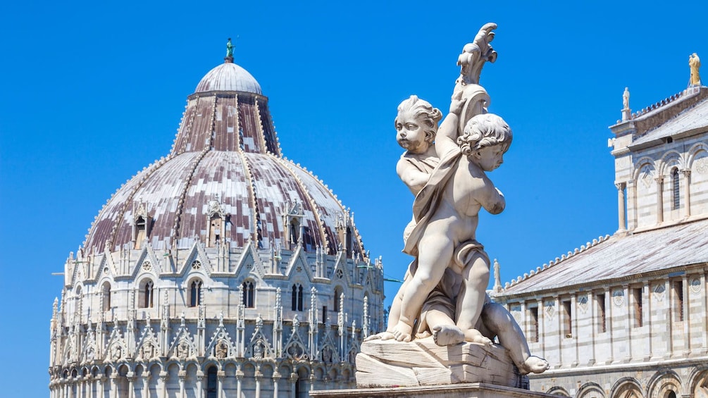 Statue of Angels with the Baptistry in the background in Pisa