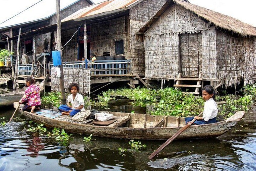 The kids are going to school with their small boat 