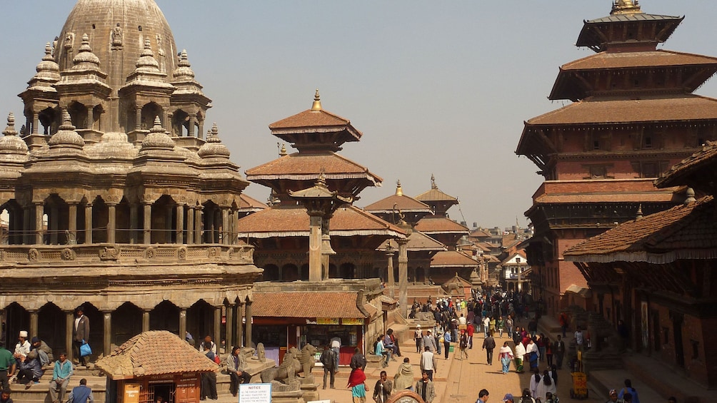Show item 1 of 10. People walking past historic buildings in Bhaktapur