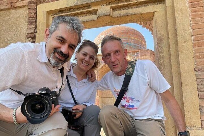 Visitors from Italy posing infront of Sultan Ibrahim tomb at Makli Necropolis 