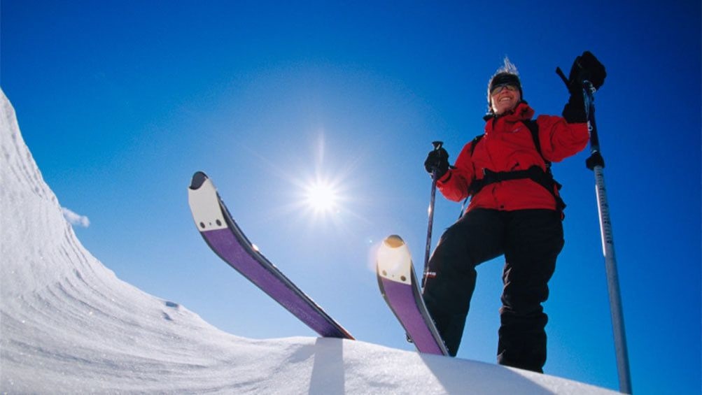 Skier poised at the top of a steep run in Park City