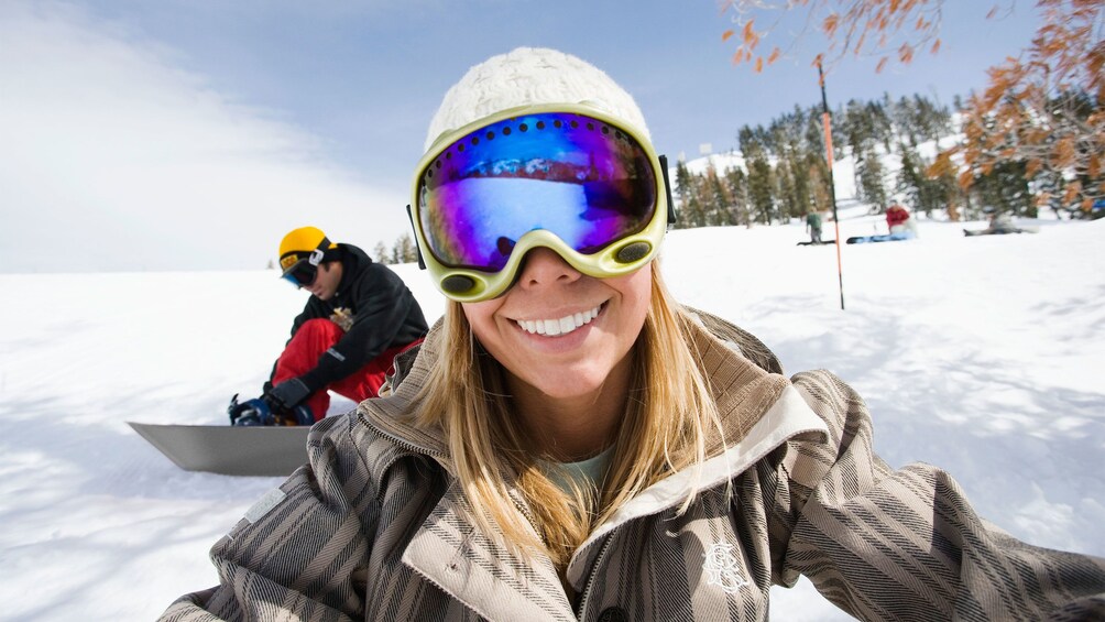 Smiling snowboarding woman on the slopes in Park City