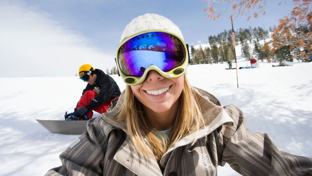 Smiling snowboarding woman on the slopes in Park City