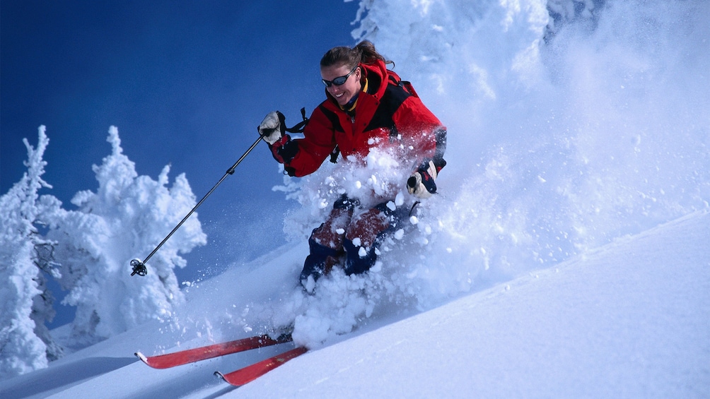 Skier traversing the slopes on a clear day