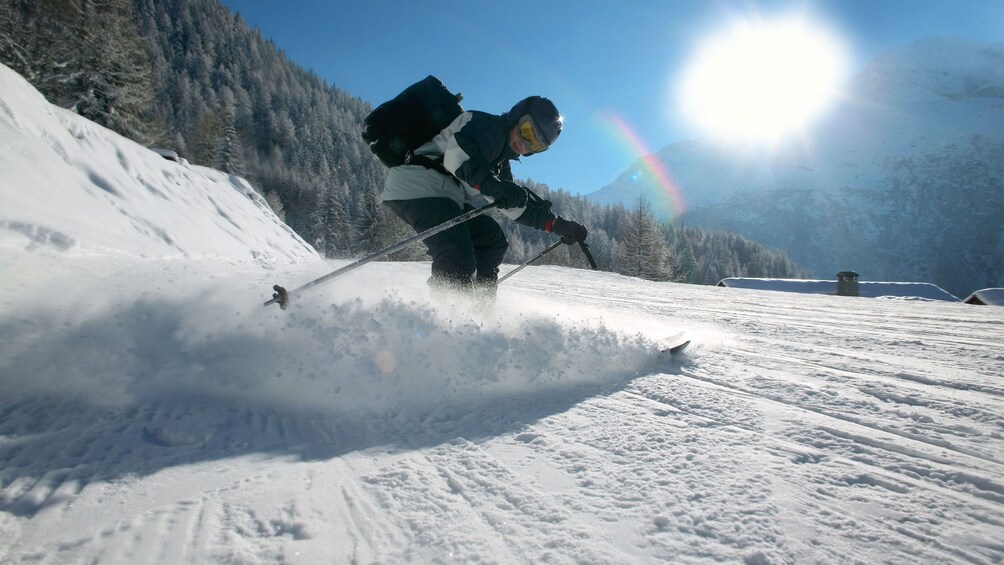Enjoy clear skies and fresh snow while skiing down the slopes of Alta