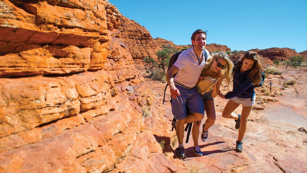 Hiking group walking along the rocks of Kings Canyon in Central Australia