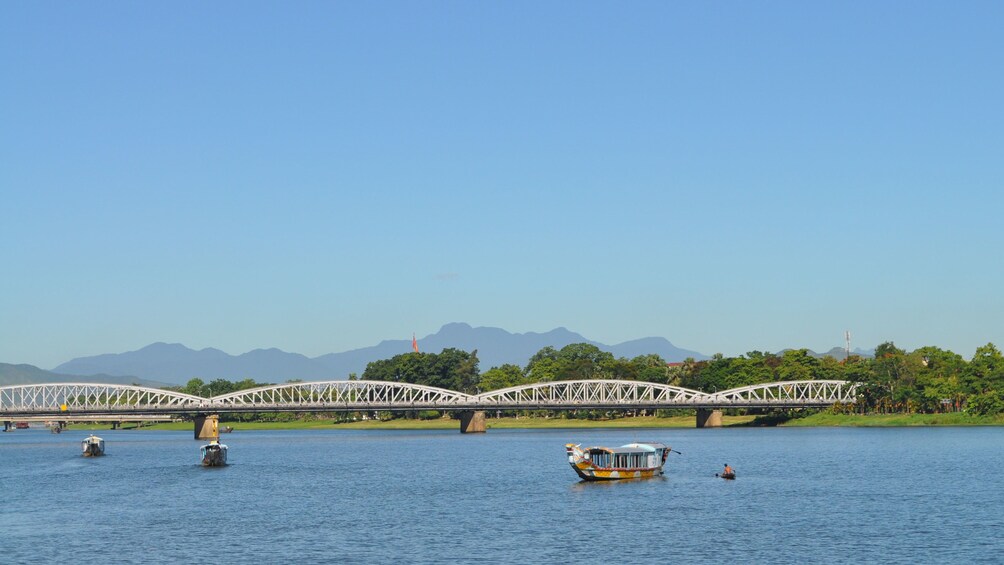 A view of boats sailing past a bridge in Ho Chi Minh