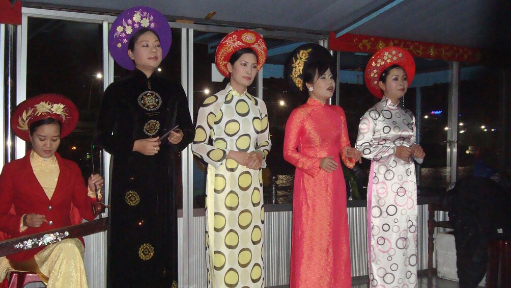 Women in traditional dresses singing in Ho Chi Minh