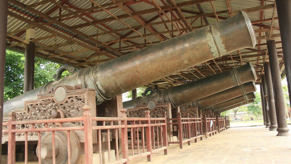 Old ornately decorated cannons on display in Ho Chi Minh