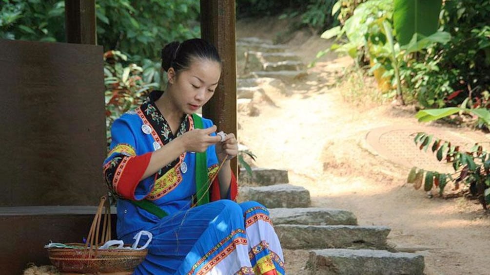 woman sitting on steps near shenzhen