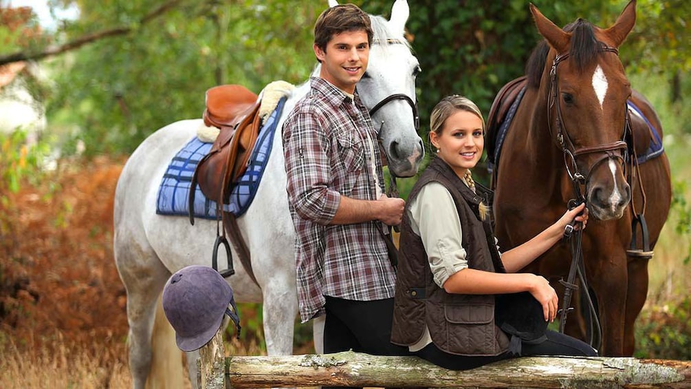 couple relaxing with horses in Siena