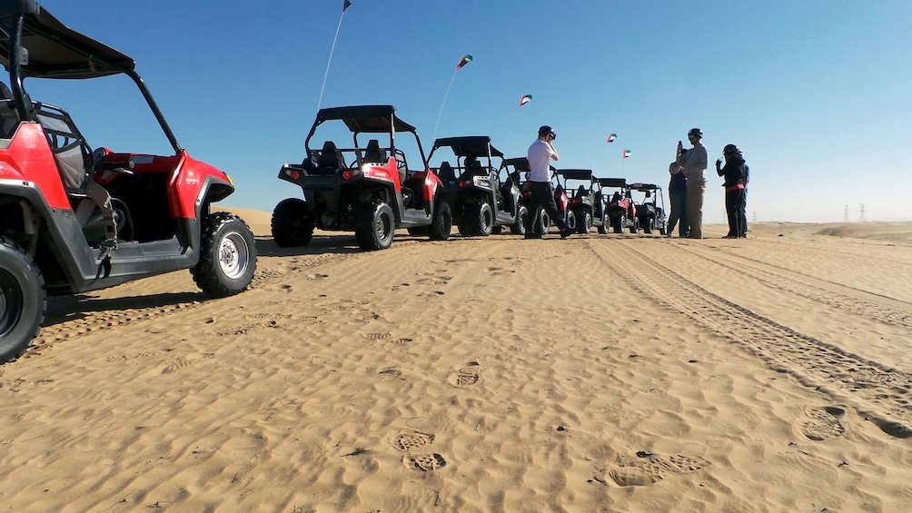 sandy buggies in a line on desert sand in Dubai