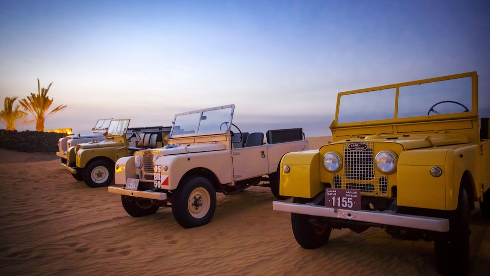 authentic antique range rovers in desert of Dubai
