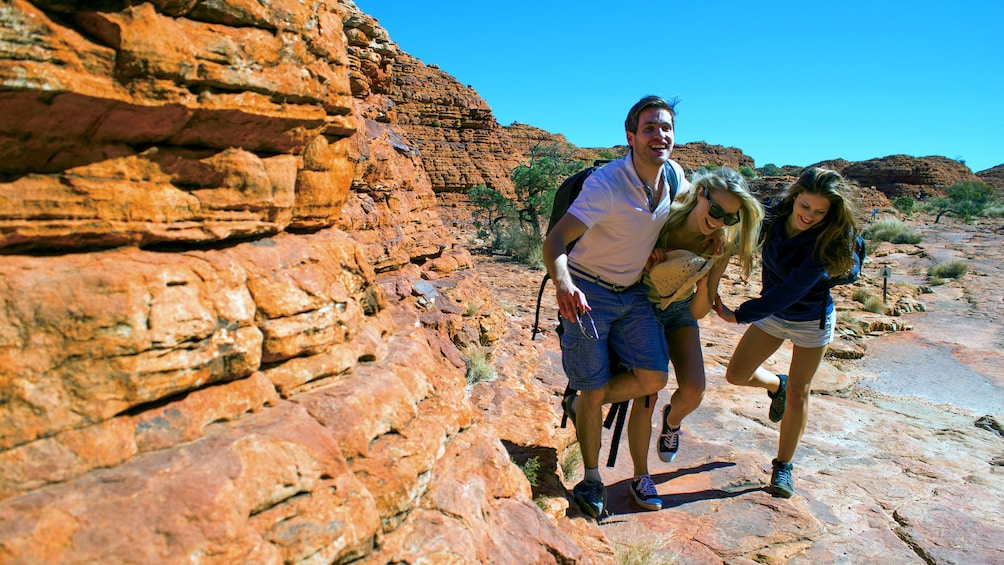 Hiking group walking along the rocks of Kings Canyon in Central Australia