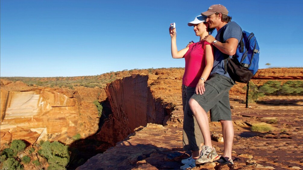 Couple taking a photo from the top of Kings Canyon in Central Australia