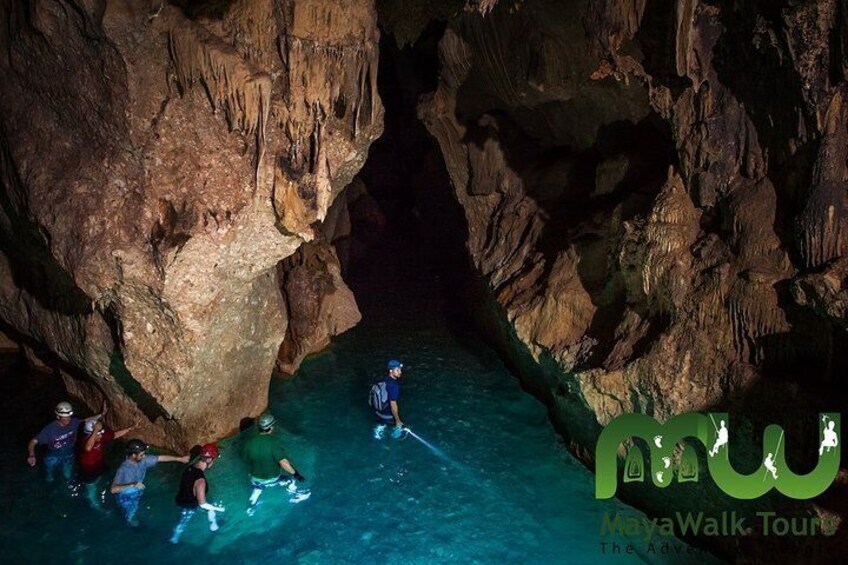 wading through the waters of the ATM cave 