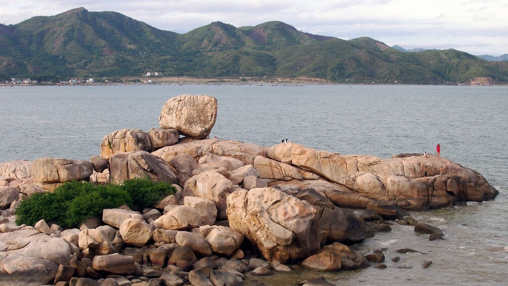 Sanding on enormous rocks at the beach in Nha Trang