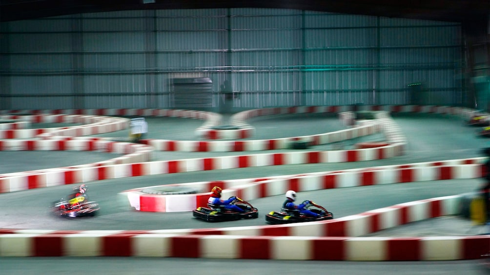 three go-karts racing on track in Abu Dhabi