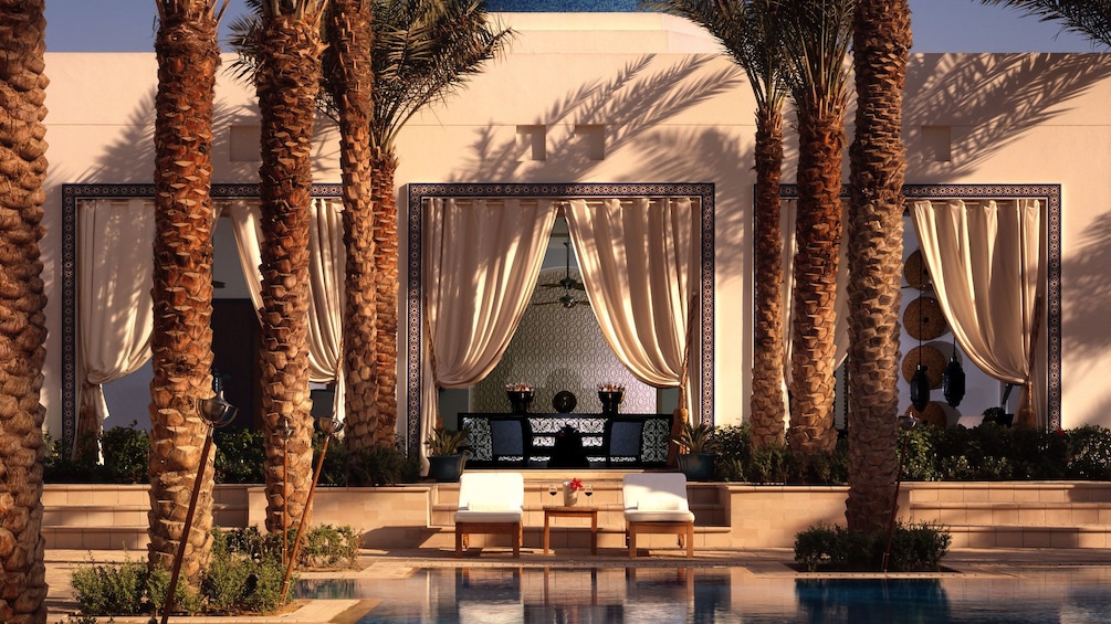 Show item 1 of 5. palm trees and swimming pool at spa in Abu Dhabi