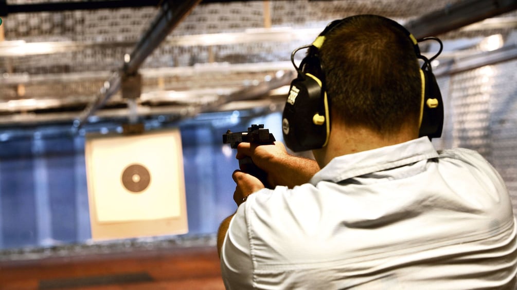 man firing gun at shooting range in Abu Dhabi