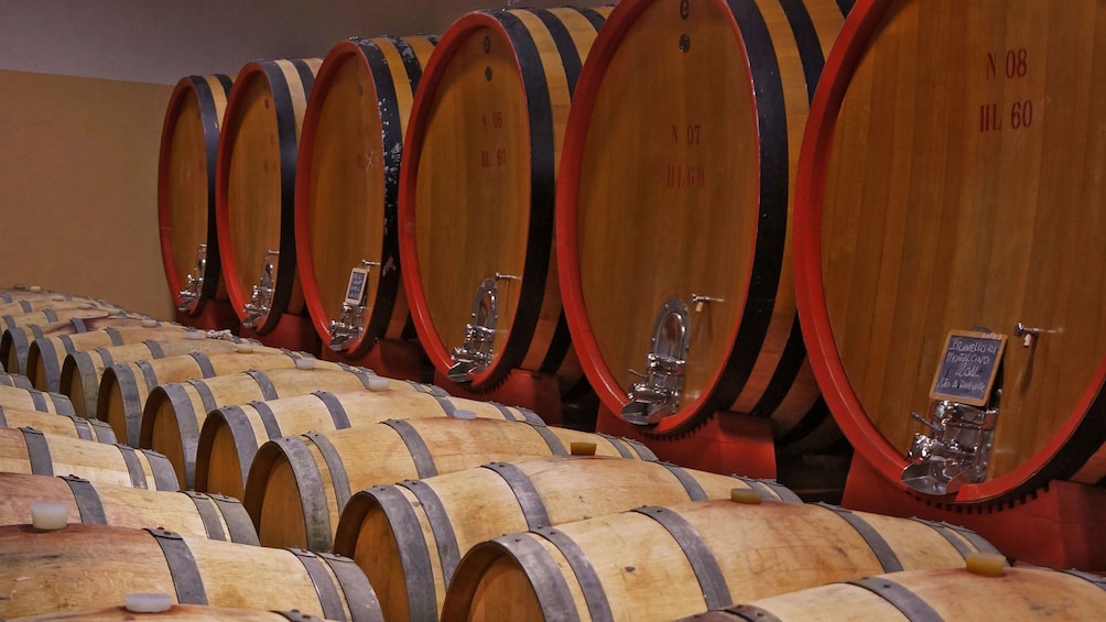 stacked wine barrels in Italy