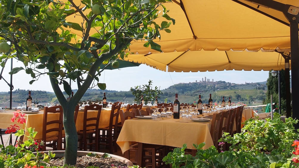 wine and dining tables set up outdoors in Italy