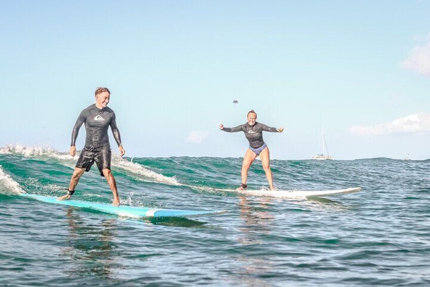 A happy couple surfing together.