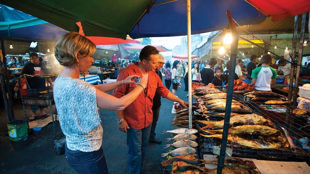 Show item 1 of 5. People enjoying the sights of the Gadong Night Market