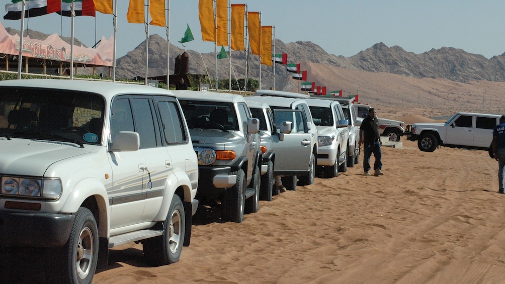 Line of SUVs near tents in Dubai