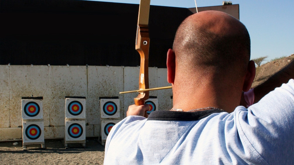 Show item 5 of 5. man at archery competition in Abu Dhabi