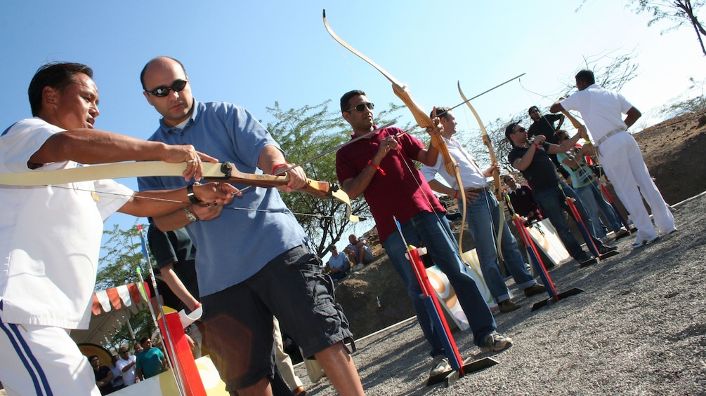Show item 3 of 5. men at archery competition in Abu Dhabi