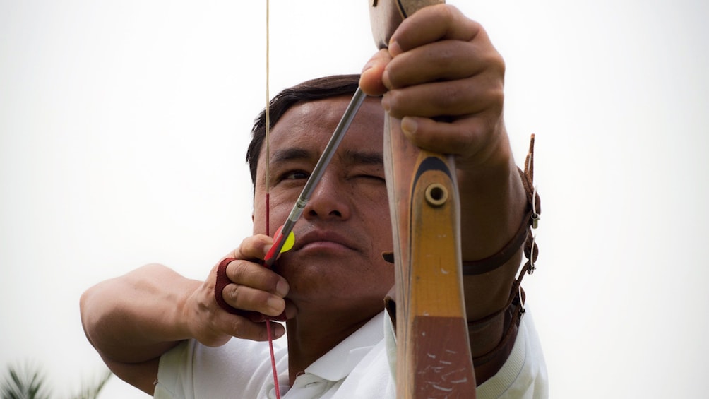 Show item 1 of 5. man at archery competition in Abu Dhabi